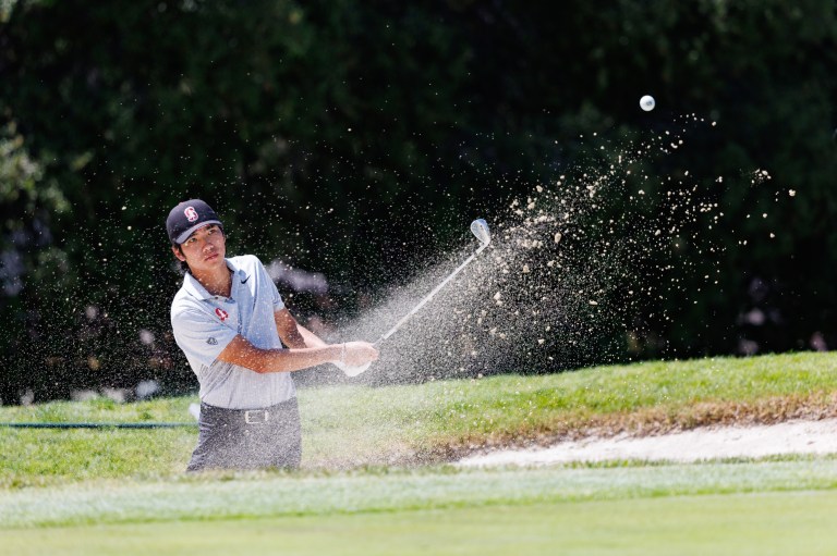 A person swinging a golf club.