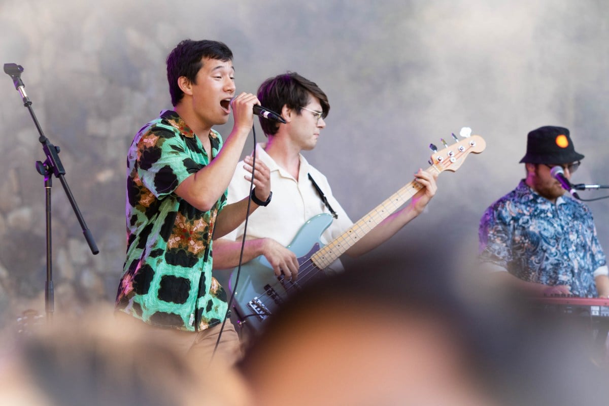 Bassist Noah Bartelt ’23 M.A. ’24, vocalist Grayson Armour ’23 M.S. ’24, and keyboardist Sebastian Hochman ’26 are seen on stage performing.