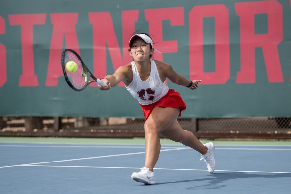 Womens tennis player reaches for the ball on the court