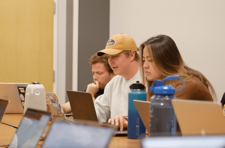 Members of the Undergraduate Senate sit around a table in discussion