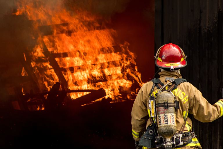 Firefighter looking at a fire.