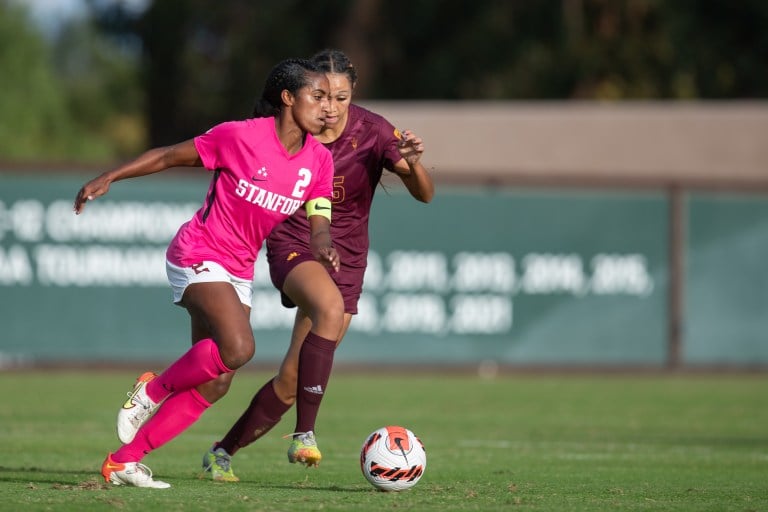 two women playing soccer