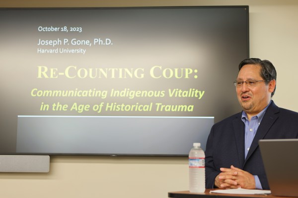 A professor stands at the podium delivering a lecture.