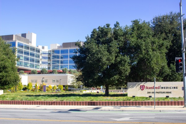 Stanford Medicine sign in front of a building with glass windows.