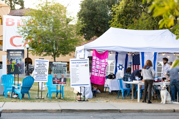 A tent with Israeli flags and informational signs on White Plaza.