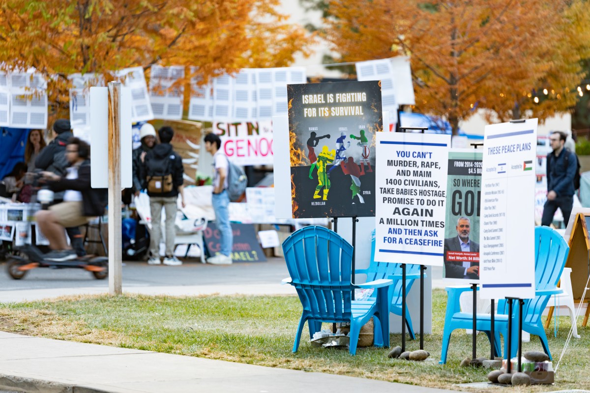 Pro-Israel signs with sit-in signs in the background.