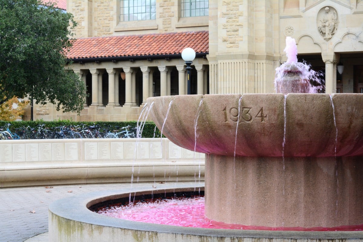 A photo of a fountain with its water stained red.