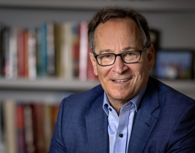 Communications professor Gary Pomerantz smiles toward the camera