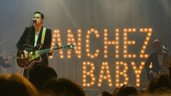 Stephen Sanchez on the stage. In the background are LED lights that read "Sanchez Baby" in all caps.