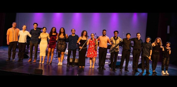 Stanford Afro-Latin Jazz Ensemble members stand side by side on stage.