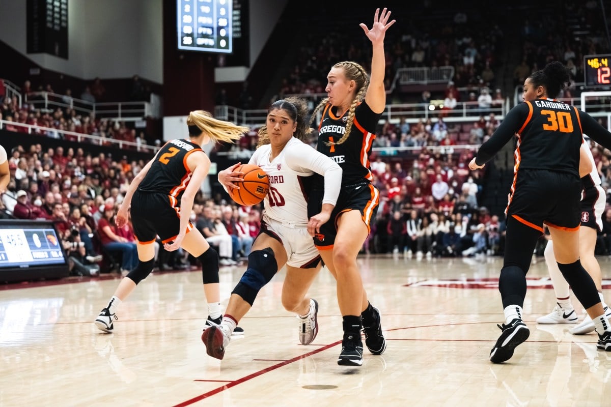 A Stanford guard rushes past an Oregon defender.