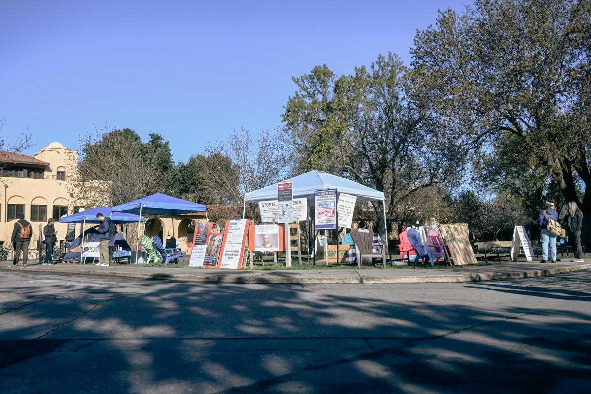 The corner of White Plaza with the blue and white tent next to another tent.