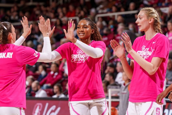 Kiki Iriafen greets her teammates before a game against Cal.