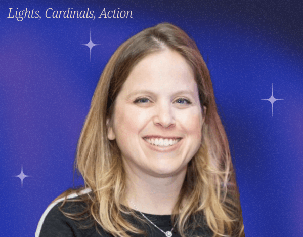 Photo of woman, Cathy Yuspa, smiling with purple background.