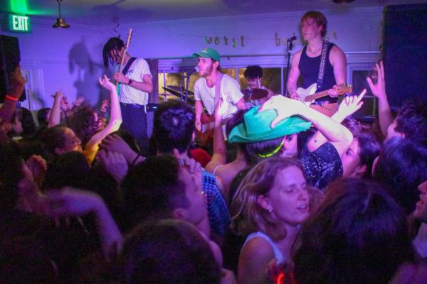 Purple lighting shines upon Banana Bred as they perform at 650 Mayfield in front of a crowd of students during Lover's Rock.