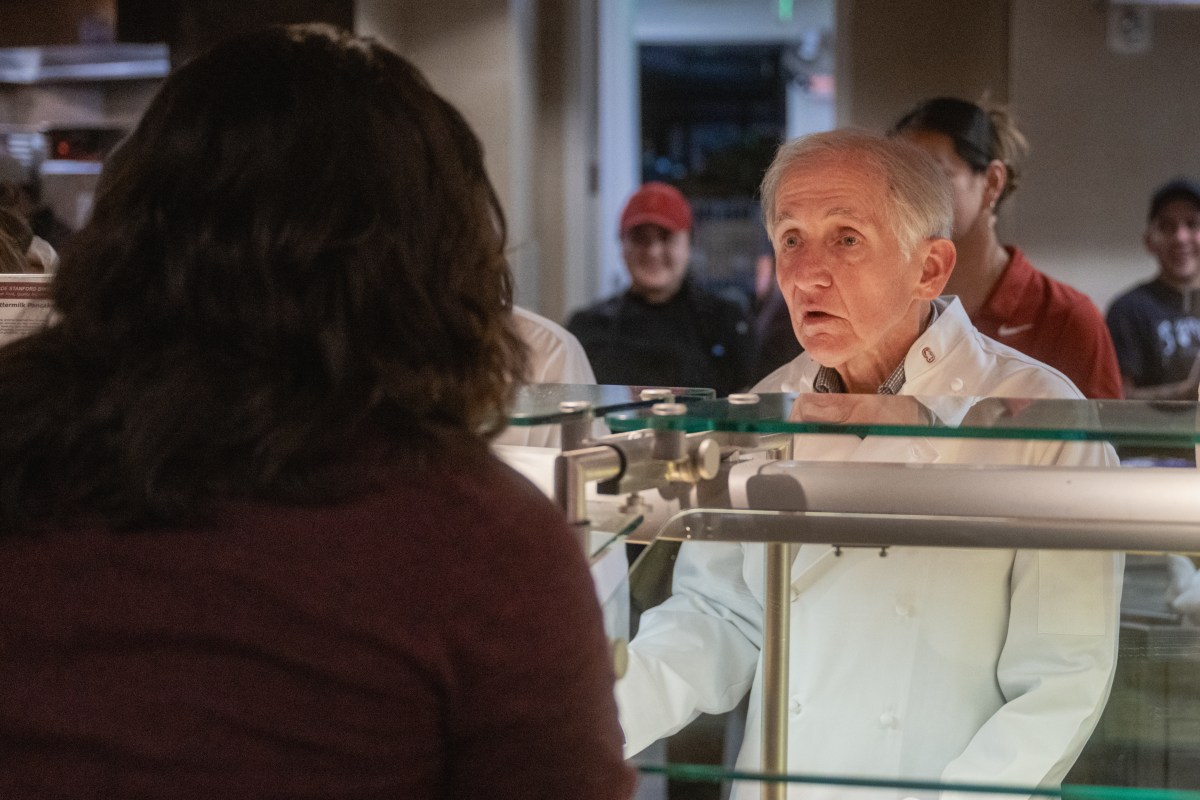 Richard Saller serves food at a dining hall.