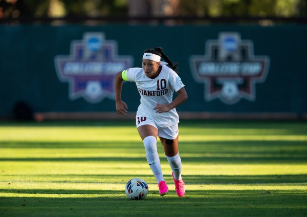 Maya Doms dribbling soccer ball.