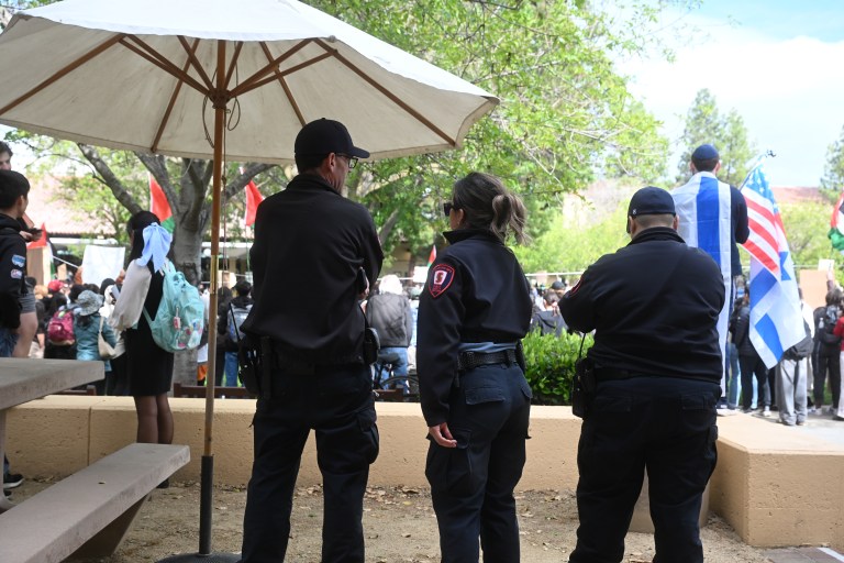 Three police watch the protest