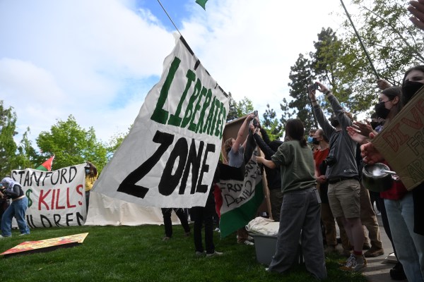 A poster that reads the liberation zone amid tents and other posters.