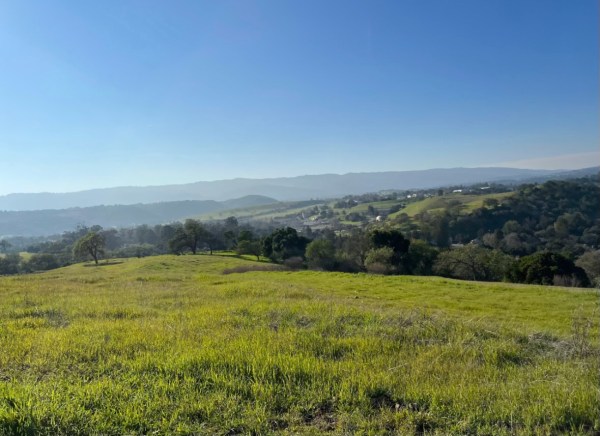 An overlook at a grassy hill.