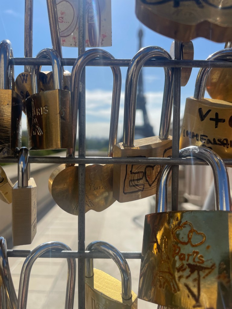 A metal grid with engraved or Sharpied locks on it (with initials and messages)