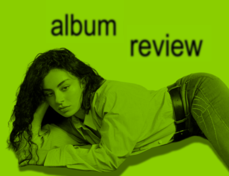 Charli XCX lying down in front of a green background, with the words "album review" hovering over her.