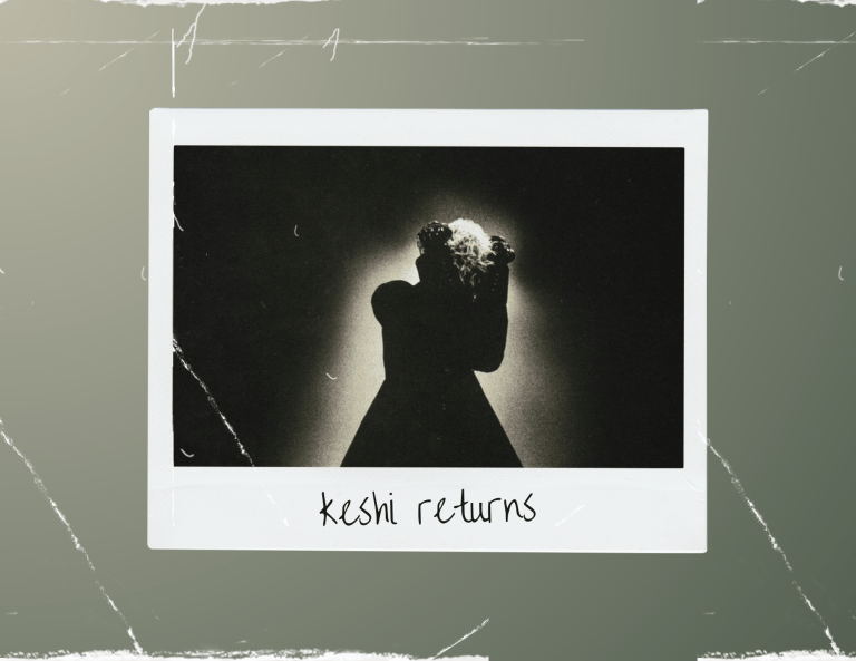 A polaroid photo depicts the cover for keshi's single, "Say," which shows a man with white hair and a black coat with his head covered by his arms and a black background. The words "Keshi returns" are written on the photo.