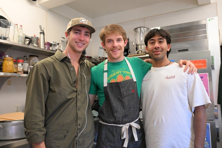 Group photo of the Street Meats trio, standing together and smiling in the Hamm kitchen