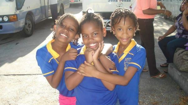 A photo of three young girls standing together