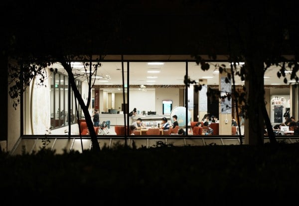 Students study in Green Library at night.