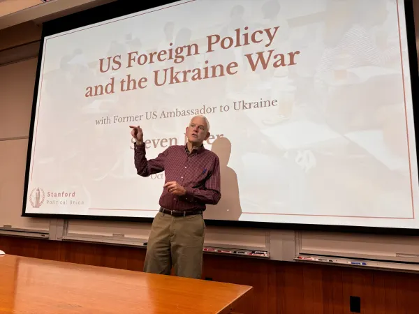 Former U.S. Ambassador Steven Pifer standing in front of a screen.