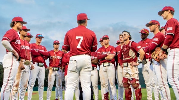 Stanford baseball players standing in a circle on the field