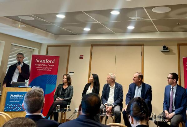 a group of speakers on a panel