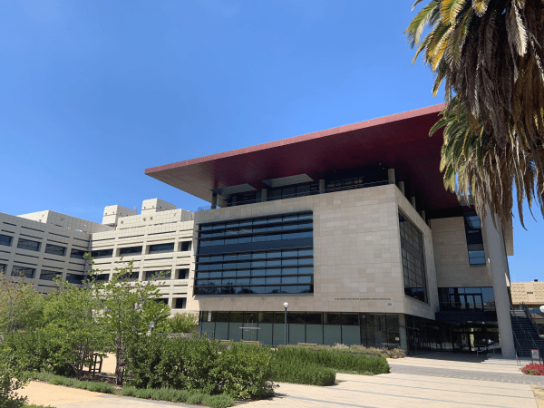 A building with large windows and a red roof