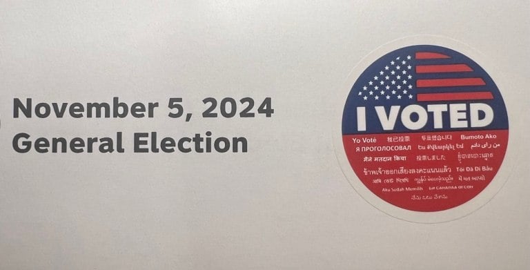 Piece of paper reading "November 5, 2024 General Election." There is an "I Voted" sticker attached.