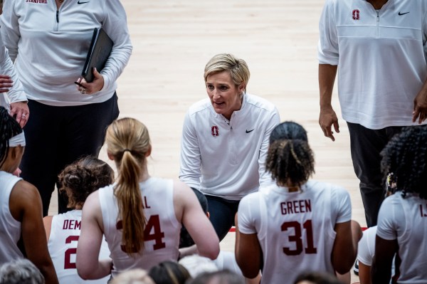 Coach talking to players on the bench