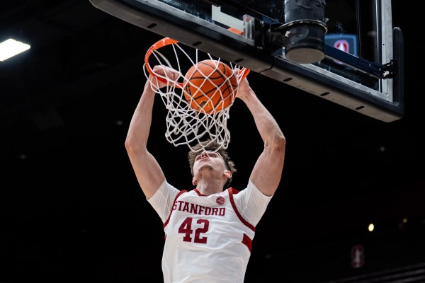 Basketball player scores during a game.