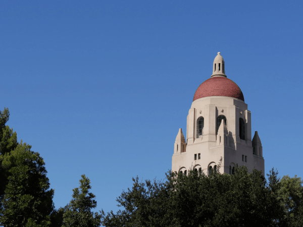 Hoover Tower rises above the trees.