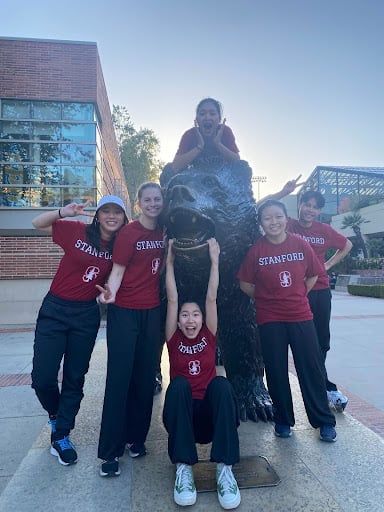 Group photo of the members of Stanford Wushu Club posing with a bear statue.